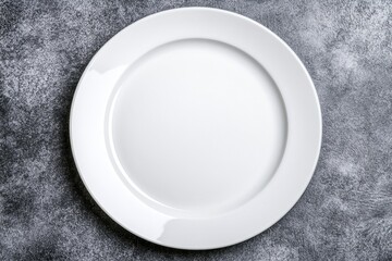 Minimalist plain white plate on a grunge concrete background, top view. Flat lay composition with copy space for a menu design or advertising concept