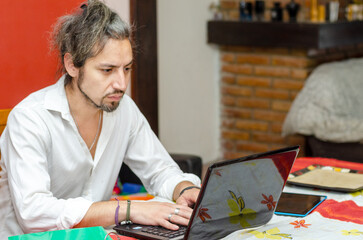 Focus man working from home with a laptop computer
