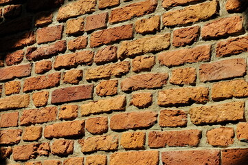 Texture, wallpaper, sunlight falls on a red brick wall