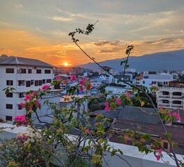 A breathtaking sunset over the rooftops of Chiang Mai, Thailand, casting golden hues across the city