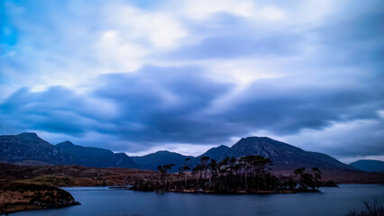Blue hour at Pine Island under cloudy full moonlight, with the Twelve Bens in the background, Connemara, Ireland.