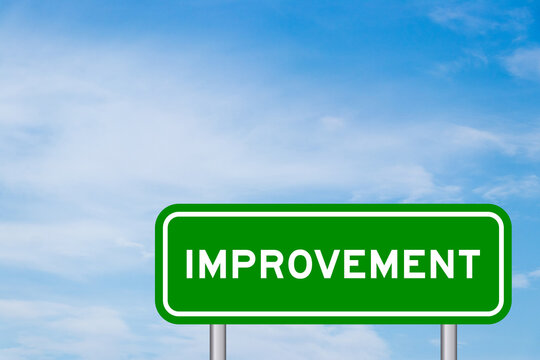 Green color transportation sign with word improvement on blue sky with white cloud background