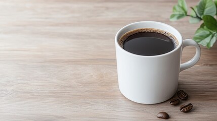 Coffee cup on wooden table, plant in background