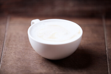 Cappuccino on dark wooden background. Soft focus. Close up.