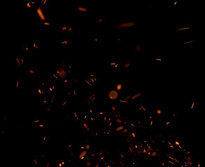The image is a black and white photo of a fire with a lot of smoke and sparks
