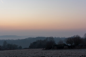 French countryside, misty, frost, winter at sunrise or sunset.