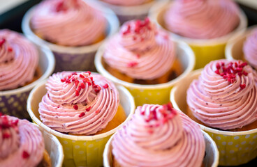 Group of delicious muffins with tasty cream topping