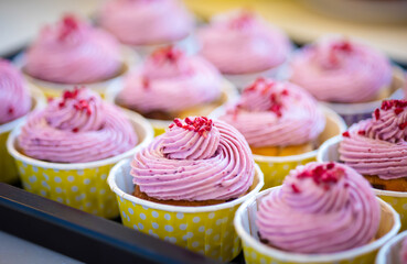 Group of delicious muffins with tasty cream topping