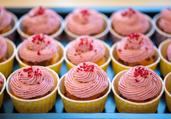 Group of delicious muffins with tasty cream topping