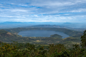 Fototapeta premium Wide angle panoramic aerial view of Lake Coatepeque with Teopan Island - inactive volcano crater lagoon in western mountain region of El Salvador near Santa Ana city.