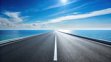Fototapeta premium Asphalt road stretching towards a tranquil ocean under a bright sunny sky, offering a scenic view of a summer day with white clouds drifting across a brilliant blue horizon