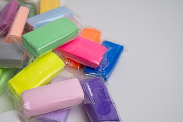 Set of colored plasticine for creativity. Plasticine dough for modeling in transparent packaging. Banner design