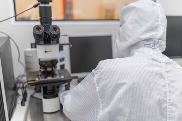Scientist in laboratory,research experiment using microscope,lab work and sample analysis,scientific research process.