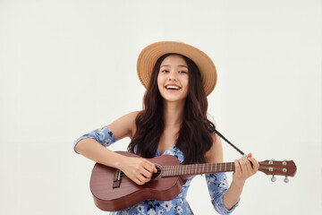 Joyful Woman Playing Ukulele in a Floral Dress