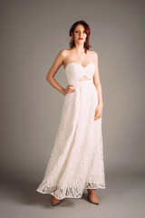 Beautiful redhead woman in studio, sensual portrait. Sweetheart neckline double layer maxi white...