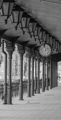 old historic railway station, passage between platforms, wooden architecture of the railway station, old clock, black and white photo © Adam
