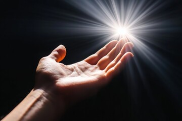 Open hand reaching towards a bright light emanating from the darkness, symbolizing hope, faith, and spiritual seeking