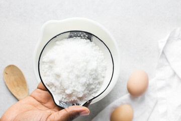 Overhead view of white sugar in a white plate, top view of granulated sugar in a plate