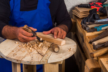 The carpenters are using spokeshave to decorate the woodwork.