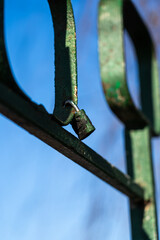 Iron, old handrails with a lock on them. Love lock on the railing