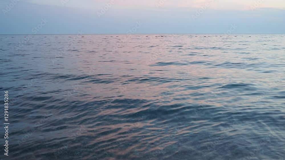Poster observe tranquil beauty as sun sets on horizon, casting soft hues across ocean. gentle waves ripple 