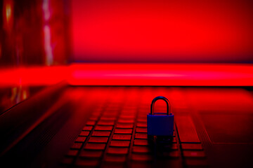 Lock symbolizes cybersecurity on modern laptop keys