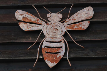 Steel decoration of bees on a wooden background