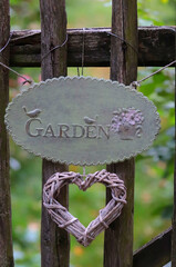 wooden fence with the inscription garden and wooden heart
