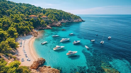 Fototapeta premium Aerial view of a pristine beach with turquoise water, boats docked along the shore 