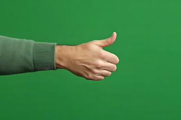 Thumbs Up on Green Screen: A close-up shot of a person's hand giving a "thumbs up" gesture against a vivid green screen backdrop, ready for easy compositing.