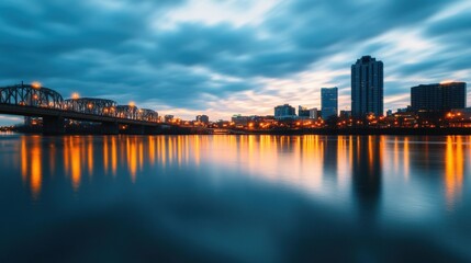 Naklejka premium City skyline at night with bridge and water reflections