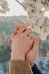 Two hands that are just engaged, and there is a ring