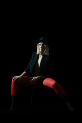 A beautiful blonde woman posing in the studio with red stockings: The Play of Red Elegance