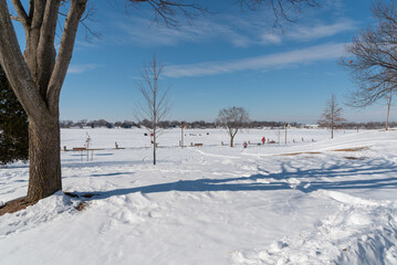 People Ice Fishing And Ice Fishing Shanties On Frozen Fox River In De Pere, Wisconsin, In February