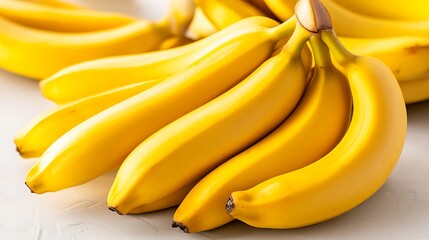 Fresh yellow bananas bunch on white surface