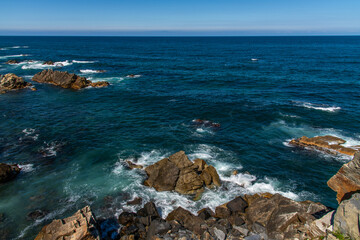 View of the rocky seaside with surf