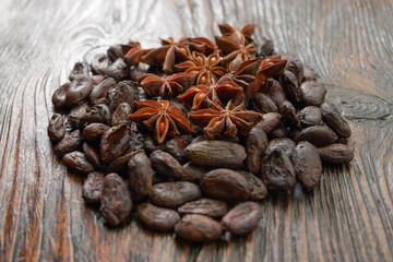 Broken dark chocolate and cocoa beans on the table