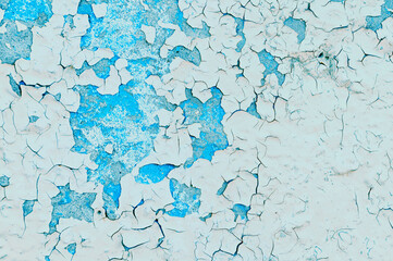 Light beige and turquoise peeling paint on the old rough concrete surface - texture paint background, peeling paint pattern