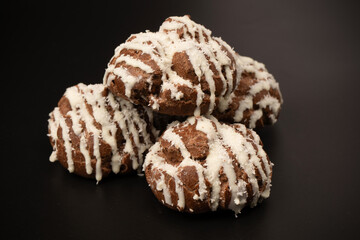 Profiteroles with coconut cream on a black background.