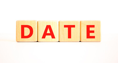 Date symbol. Concept word Date on beautiful wooden blocks. Beautiful white table white background....