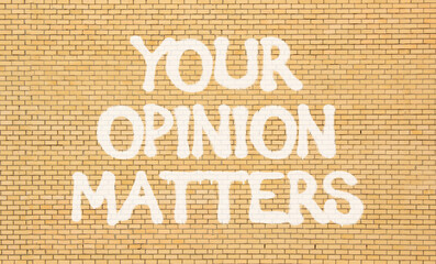Your opinion matters symbol. Concept words Your opinion matters on beautiful brown brick wall....