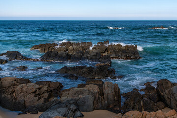 View of the rocky seaside with surf