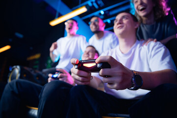 Closeup gamepad, Diverse group of young friends playing cyber game in esports setting