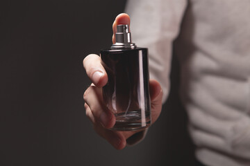hand with bottle of perfume