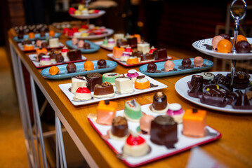 Delightful assortment of artisan chocolates displayed on a vibrant plate at an event dedicated to sweet treats during a festive gathering