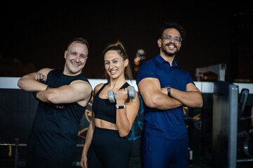 Smiling Fitness Group Posing For Photo During Nighttime Workout