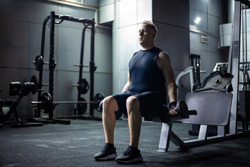 Man Lifting Weights During a Workout in a Modern Gym