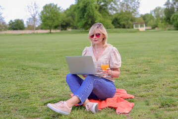  young beautiful female freelancer sitting with a laptop. Education online.woman running outdoors.