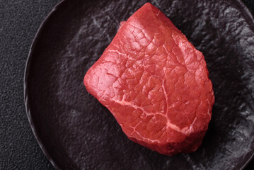 Raw beef tenderloin ribeye steak with salt and spices