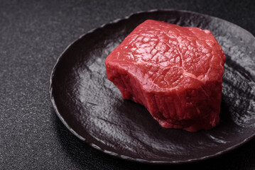 Raw beef tenderloin ribeye steak with salt and spices